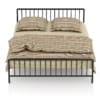 Metal Bed with Striped Bedclothes